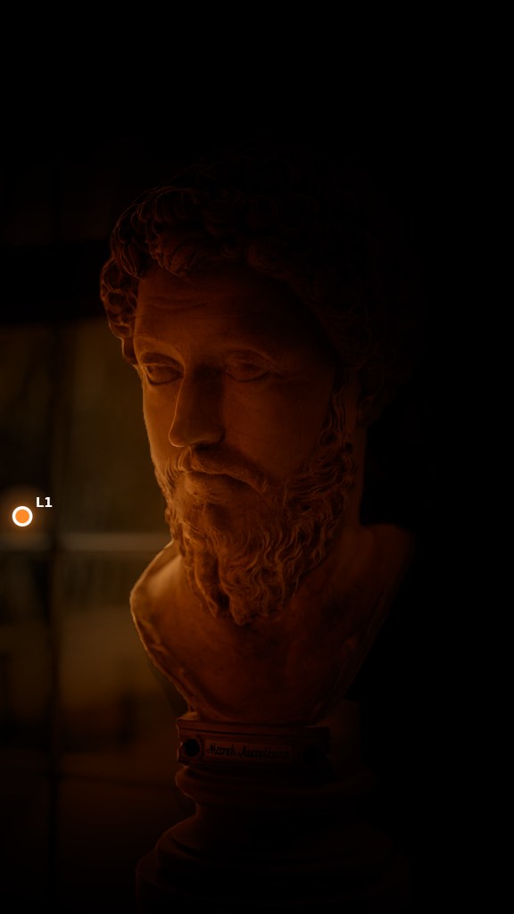 The bust lit by a dim, tight candle from the left