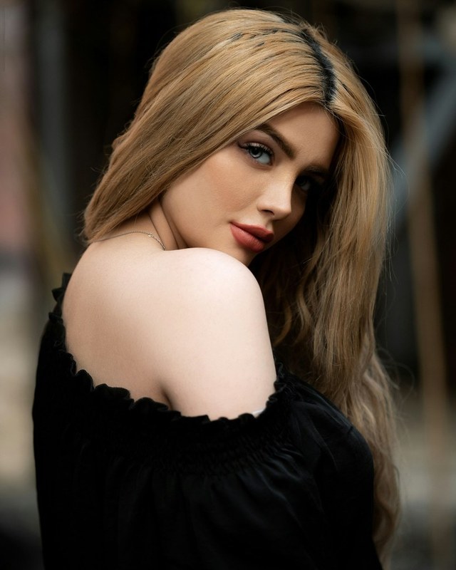 A stock photograph of a woman looking back over her shoulder